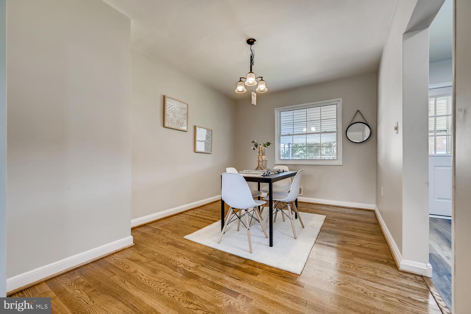 2720 Moorgate Road Baltimore, MD 21222 - Photo 8 of 28 a view of a dining room with furniture a chandelier and wooden floor