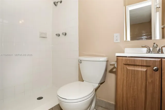 a white toilet sitting next to a bathroom sink