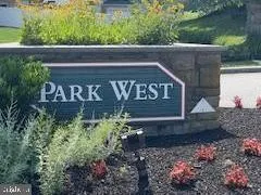 a view of sign board with plants