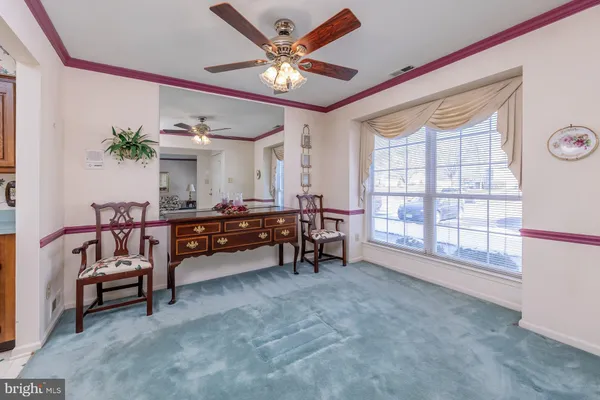 a bedroom with furniture and a ceiling fan
