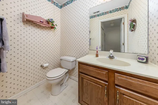 a bathroom with a sink toilet and a mirror