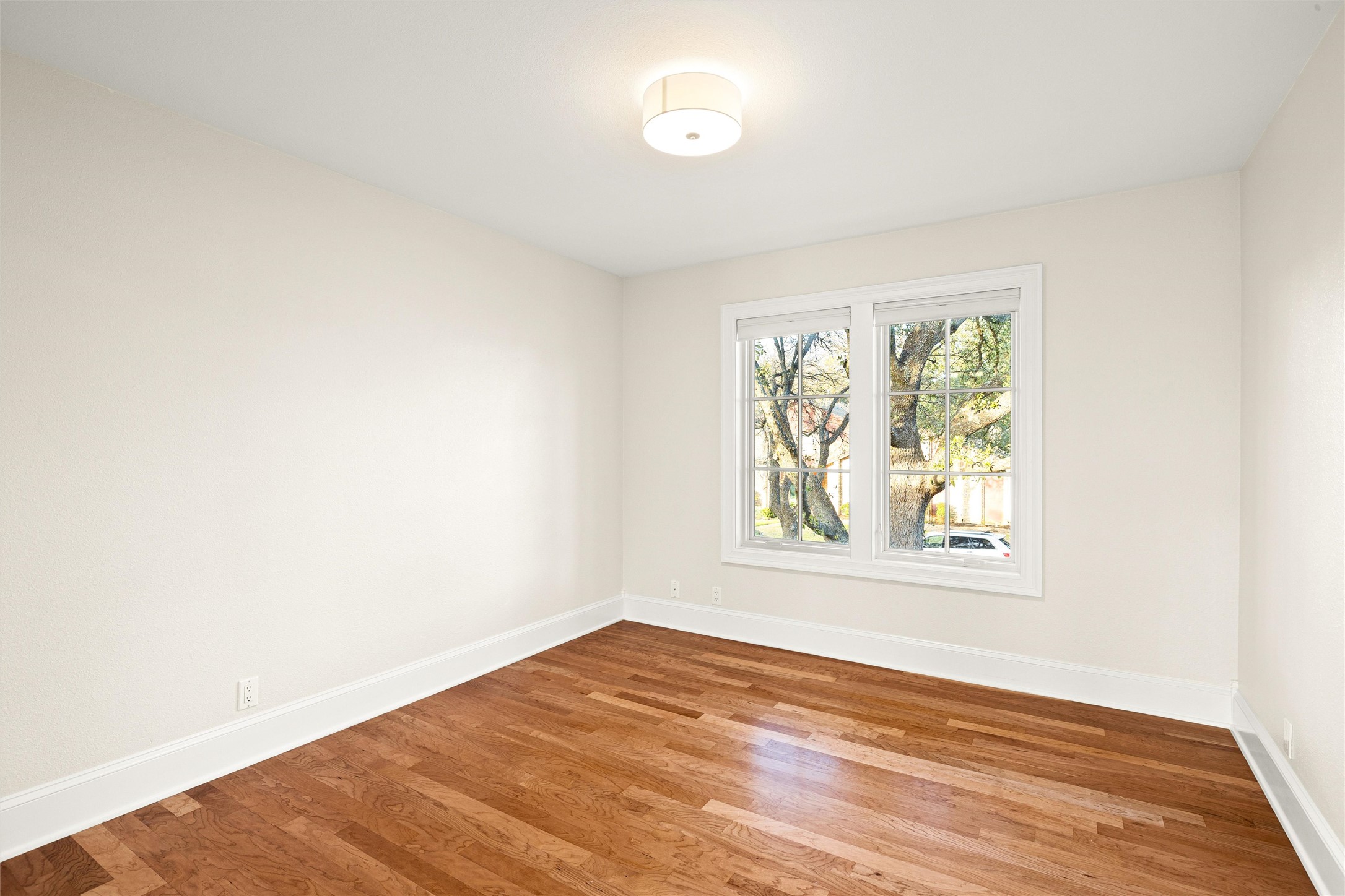 5301 Valburn Circle Austin, TX 78731 - Photo 23 of 39 an empty room with wooden floor and windows