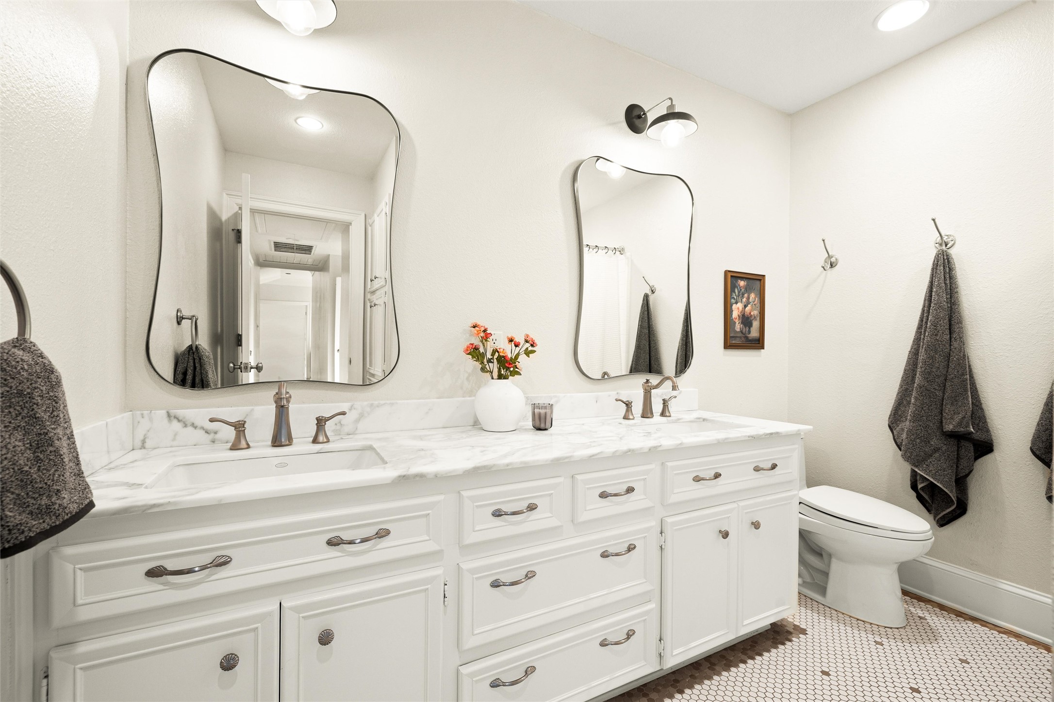 5301 Valburn Circle Austin, TX 78731 - Photo 24 of 39 a bathroom with a double vanity sink and a mirror