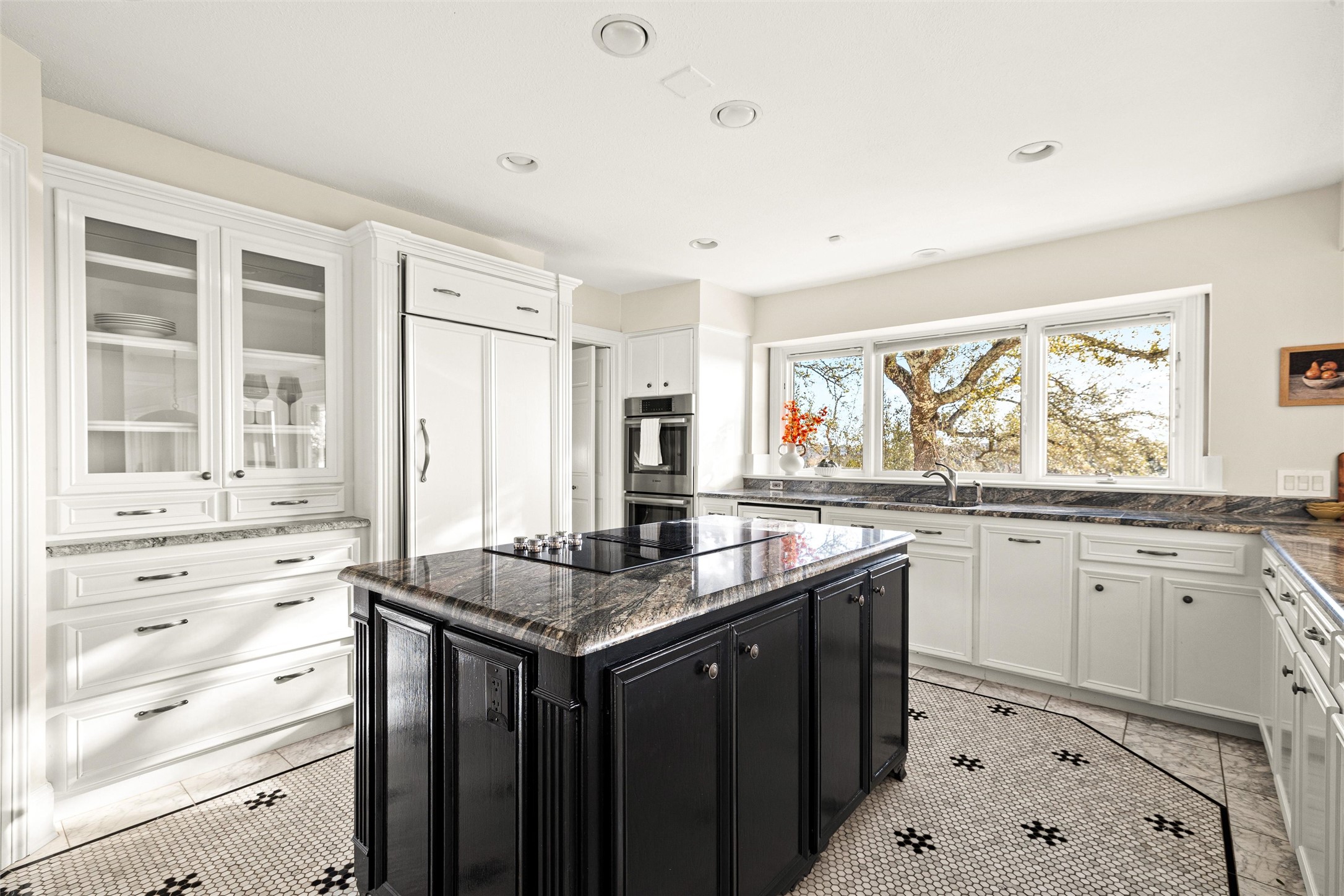5301 Valburn Circle Austin, TX 78731 - Photo 9 of 39 a kitchen with granite countertop a sink stove window and cabinets