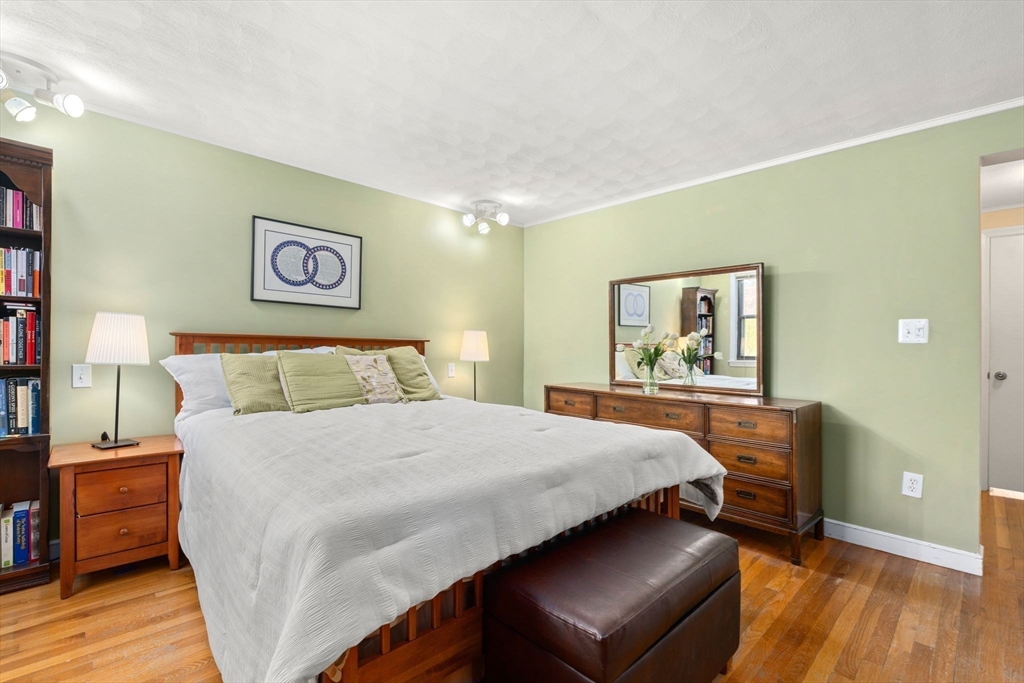 42 Stanley Road Newton, MA 02468 - Photo 16 of 29 a bedroom with a bed and wooden floor