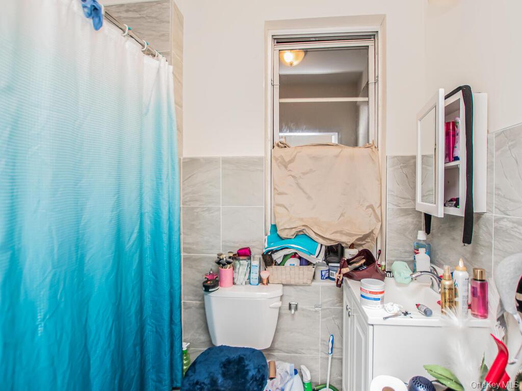 1406 White Plains Road Bronx, NY 10462 - Photo 13 of 43 a bathroom with a sink toilet and shower