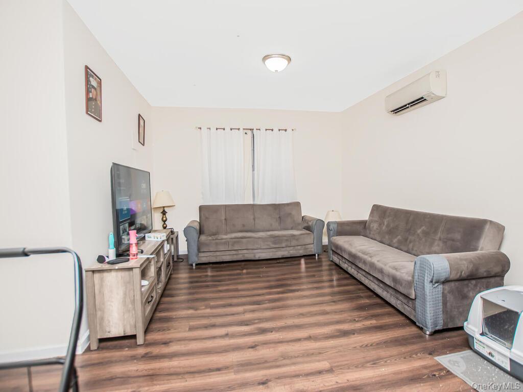 1406 White Plains Road Bronx, NY 10462 - Photo 14 of 43 a living room with furniture and a wooden floor