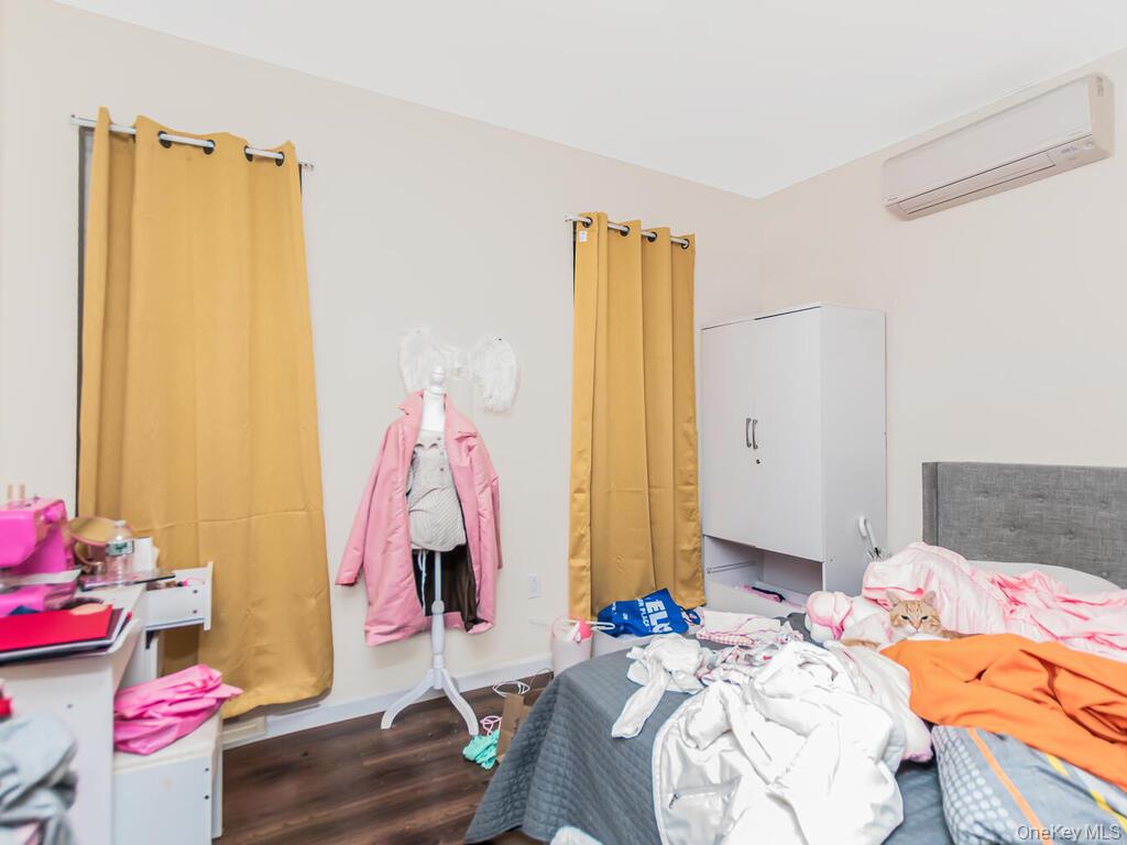 1406 White Plains Road Bronx, NY 10462 - Photo 17 of 43 a bedroom with a bed and a window