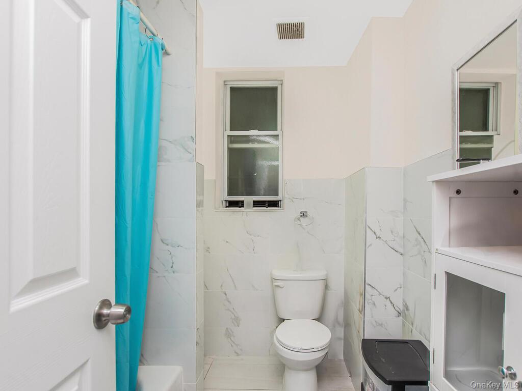 1406 White Plains Road Bronx, NY 10462 - Photo 22 of 43 a bathroom with a toilet and a sink