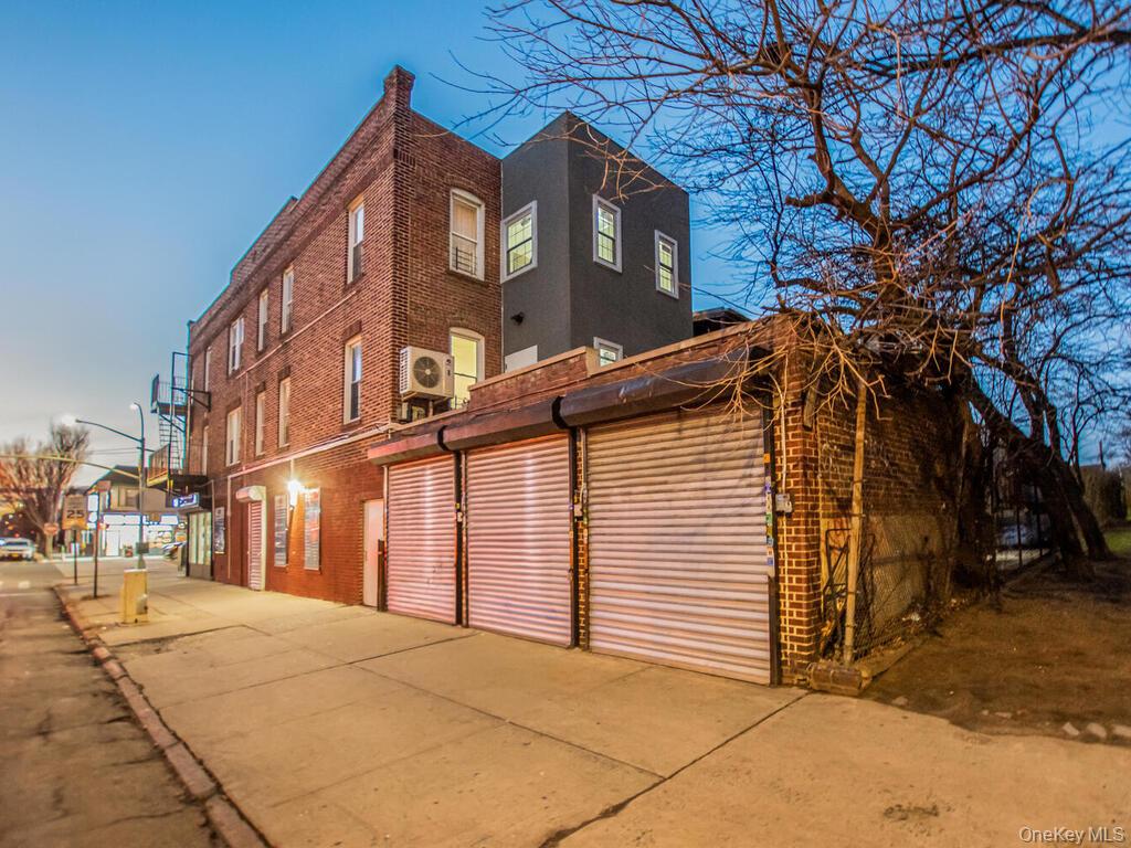 1406 White Plains Road Bronx, NY 10462 - Photo 32 of 43 a front view of a house with a yard