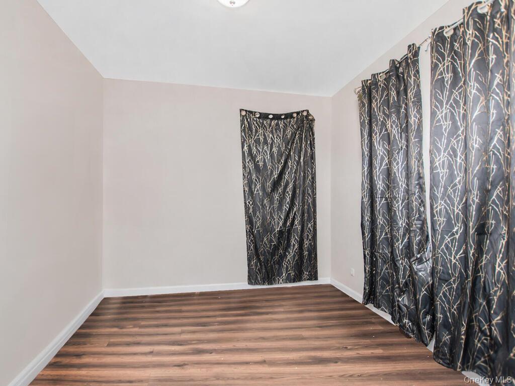 1406 White Plains Road Bronx, NY 10462 - Photo 35 of 43 a view of wooden floor with a utility room