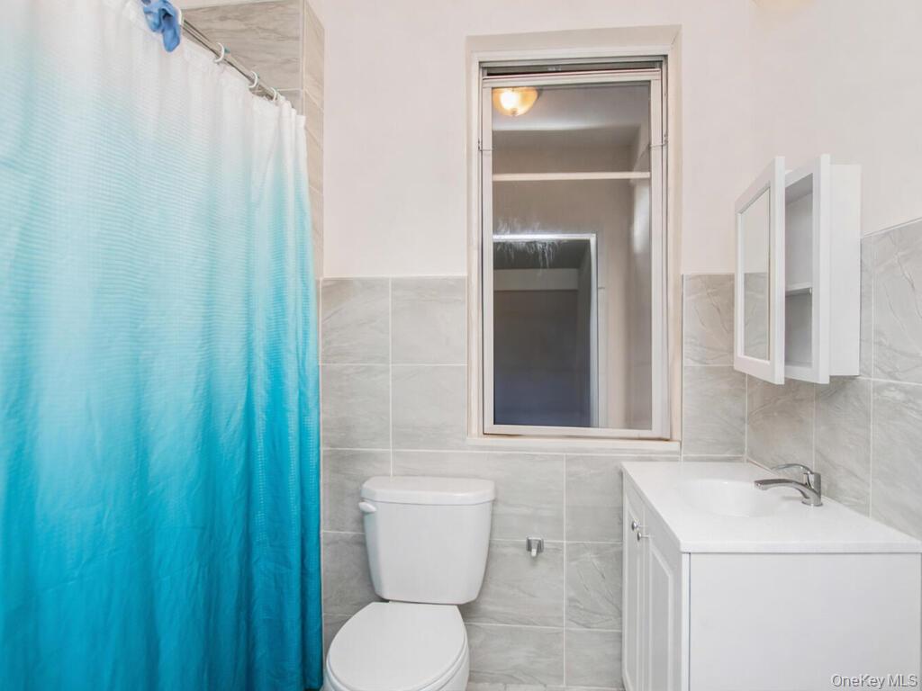1406 White Plains Road Bronx, NY 10462 - Photo 36 of 43 a bathroom with a sink and a toilet