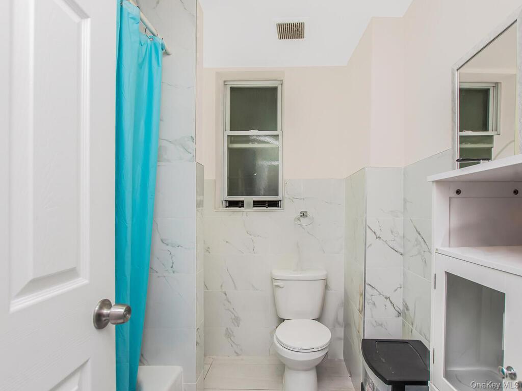 1406 White Plains Road Bronx, NY 10462 - Photo 43 of 43 a bathroom with a toilet and a sink