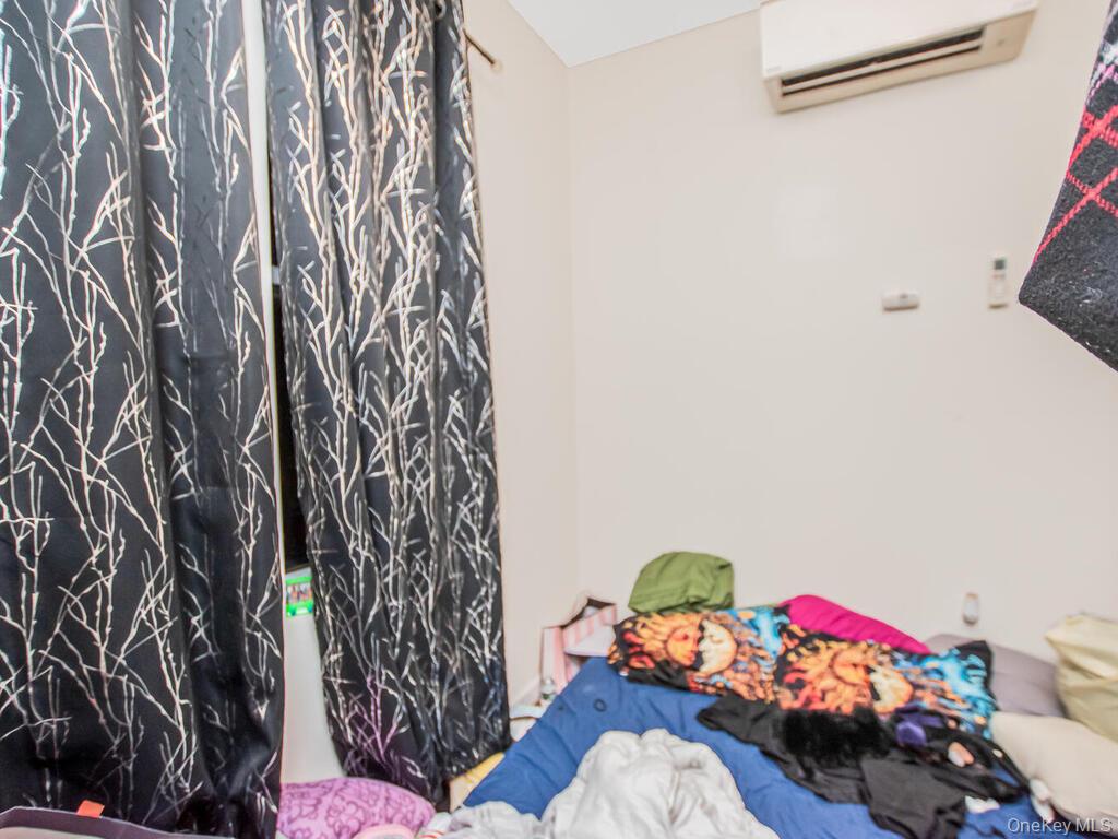 1406 White Plains Road Bronx, NY 10462 - Photo 10 of 43 a bedroom with a bed and a window