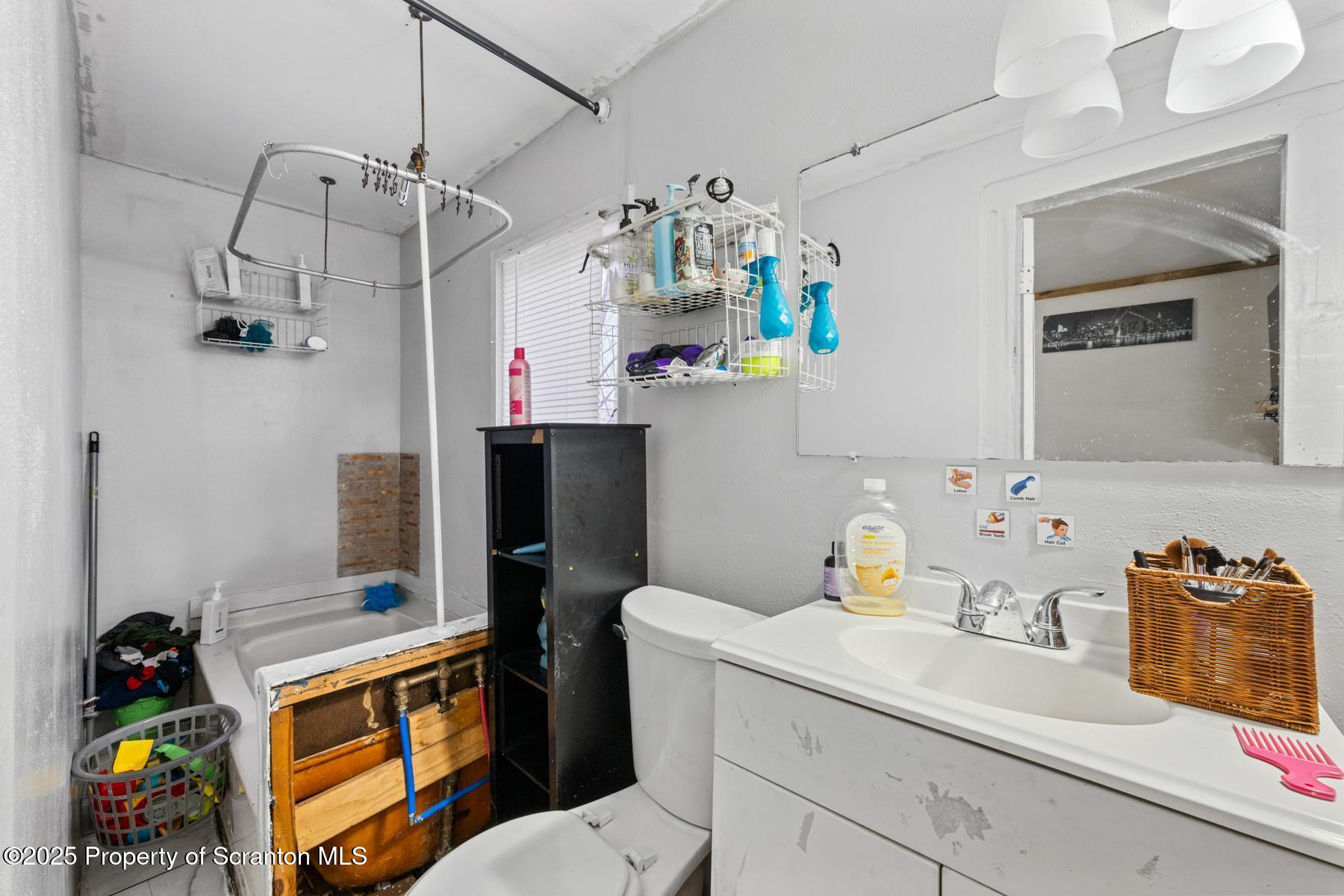 1024 South Webster Avenue Scranton, PA 18505 - Photo 28 of 38 a bathroom with a sink mirror vanity and window