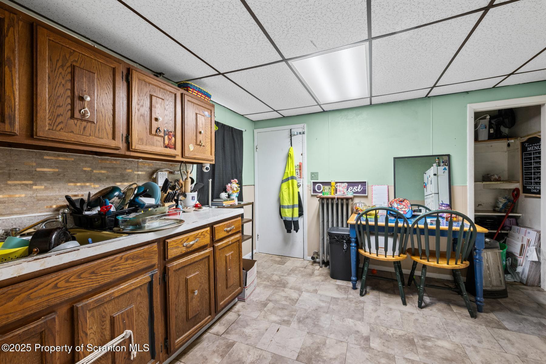1024 South Webster Avenue Scranton, PA 18505 - Photo 33 of 38 a kitchen with granite countertop lots of wooden cabinets