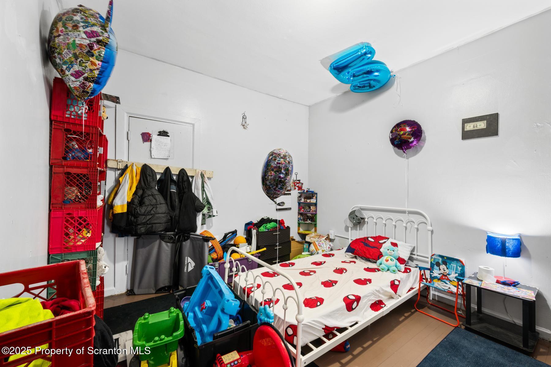 1024 South Webster Avenue Scranton, PA 18505 - Photo 36 of 38 a bedroom with bed and a chandelier