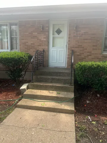 a view of house entrance door and stairs