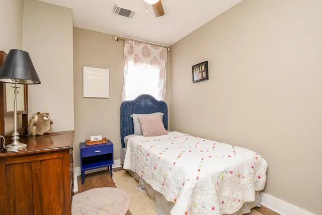 a bedroom with a bed and a dresser