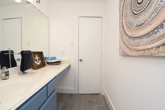 a bathroom with a sink vanity and a mirror