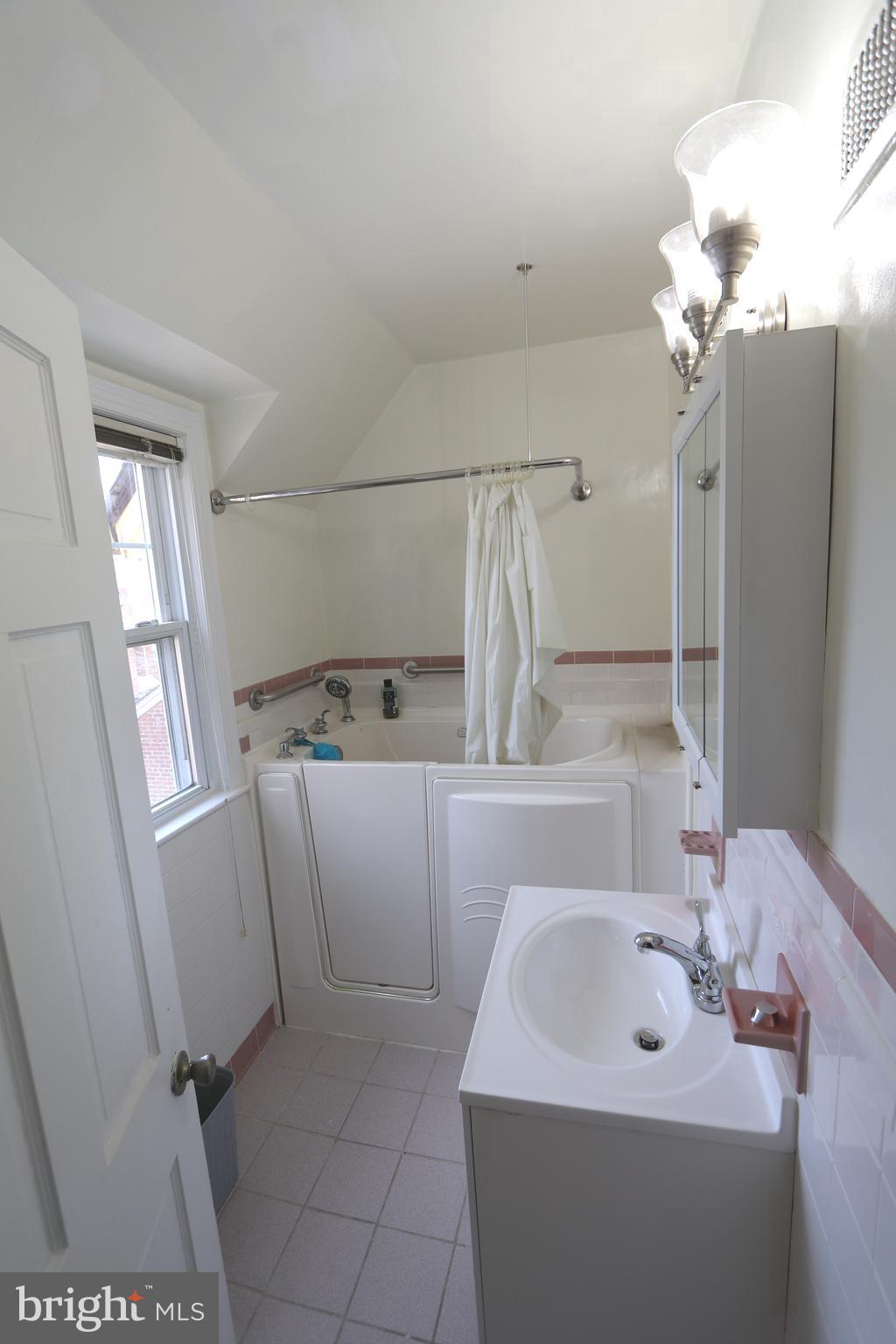 2038 34th Street Southeast Washington, DC 20020 - Photo 24 of 32 a bathroom with a sink a mirror and shower