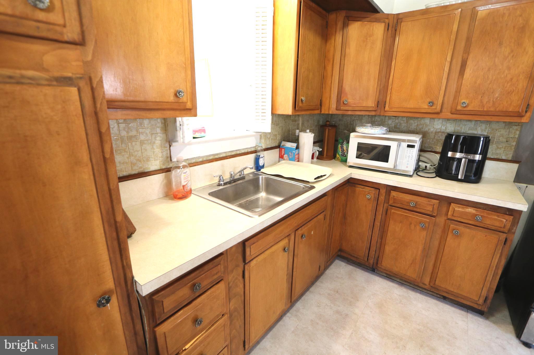 2038 34th Street Southeast Washington, DC 20020 - Photo 8 of 32 a kitchen with stainless steel appliances granite countertop a sink and a refrigerator