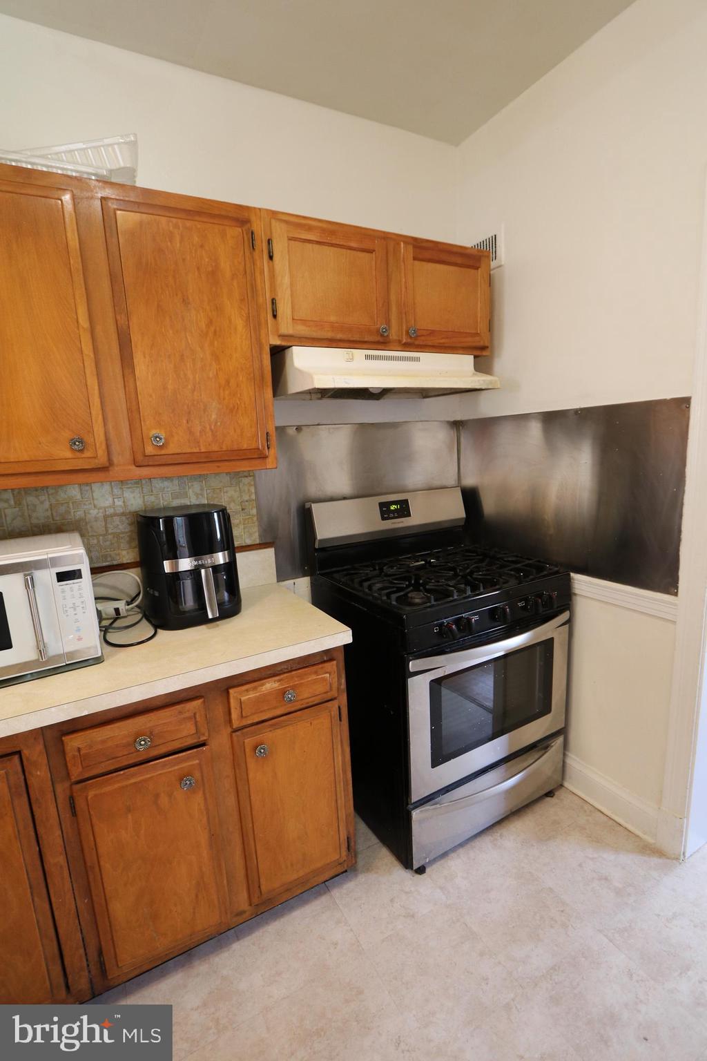 2038 34th Street Southeast Washington, DC 20020 - Photo 10 of 32 a kitchen with a stove and a microwave