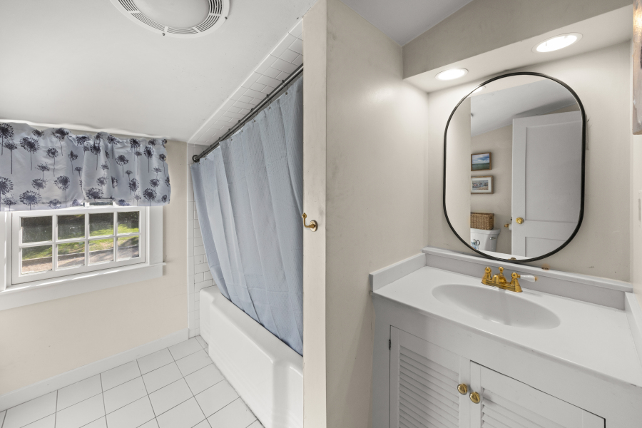 9 Fowler Avenue Edgartown, MA 02539 - Photo 21 of 27 a bathroom with a sink and a mirror