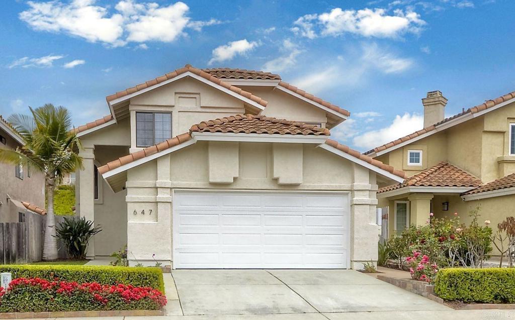647 Paseo Rio Vista, CA 92081 - Photo 1 of 1 a view of a white house with large windows and a small yard