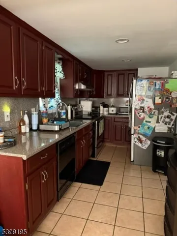 a kitchen with stainless steel appliances granite countertop a stove a sink dishwasher and a refrigerator