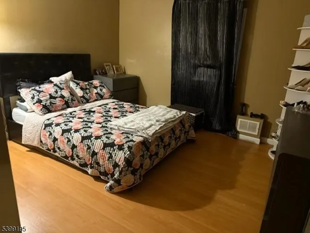 a bed sitting in a bedroom next to a bathroom