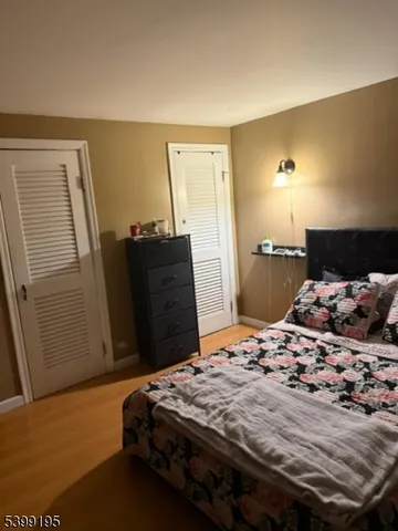 a bedroom with a bed and dresser