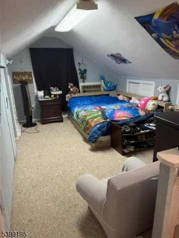 a bedroom with furniture and a flat screen tv