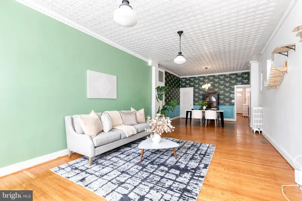 a living room with furniture and a chandelier