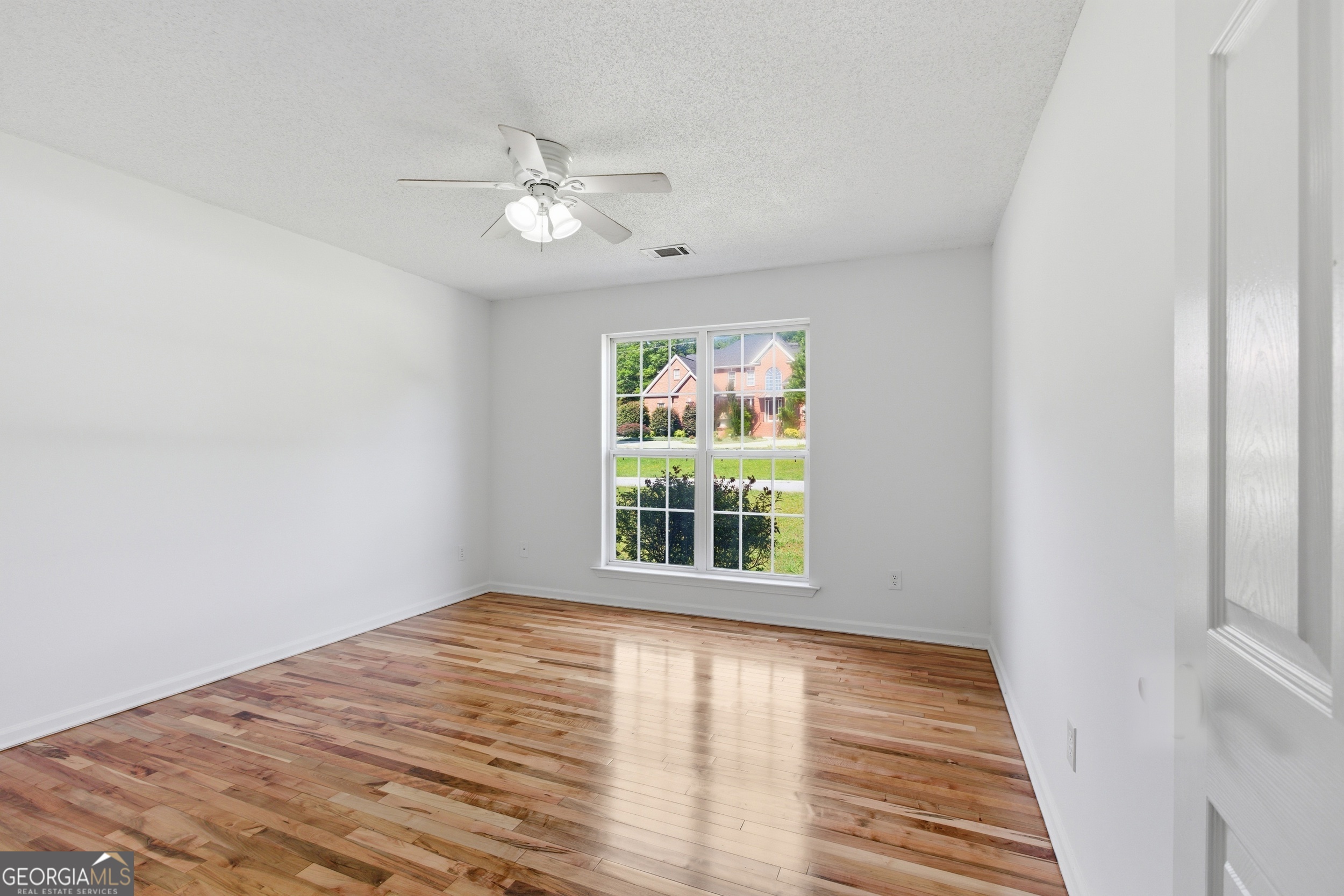 171 Winding Way Hartwell, GA 30643 - Photo 22 of 37 a view of an empty room with wooden floor and a window