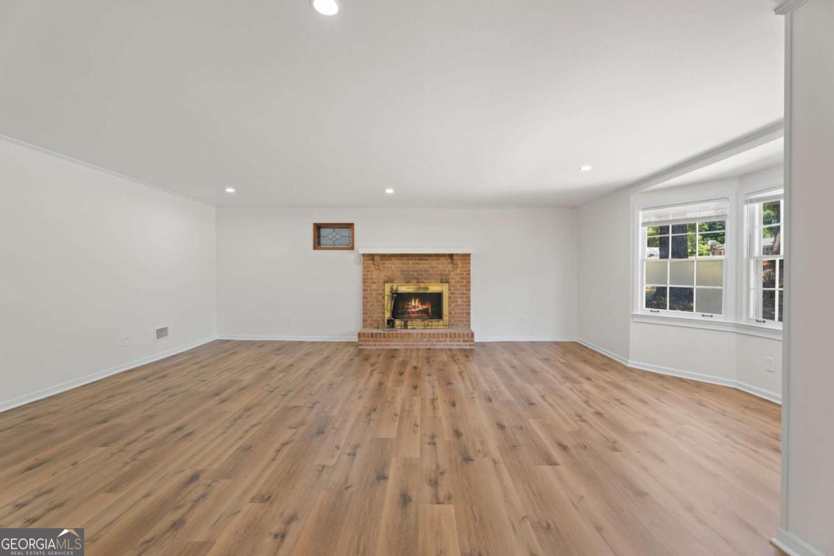 865 Old Tucker Road Stone Mountain, GA 30087 - Photo 12 of 57 a view of empty room with wooden floor and fan