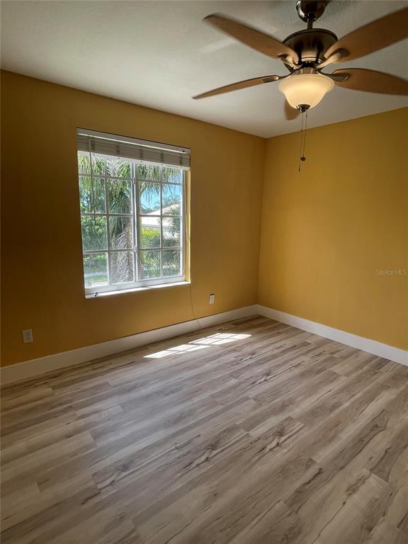 759 Fordingbridge Way Osprey, FL 34229 - Photo 19 of 51 a view of an empty room with window and wooden floor