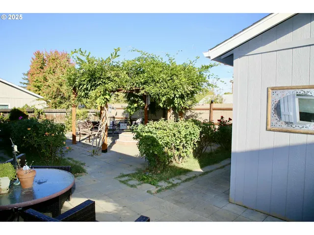 a backyard of a house with a yard and outdoor seating