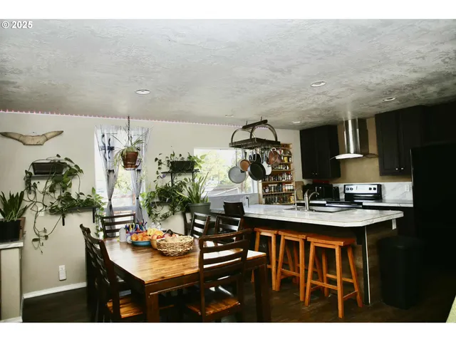 a view of a dining room with furniture and a kitchen