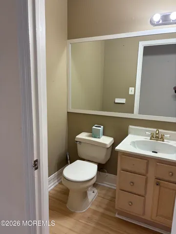 a bathroom with a toilet a sink and mirror