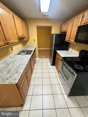 a kitchen with a sink and a stove top oven