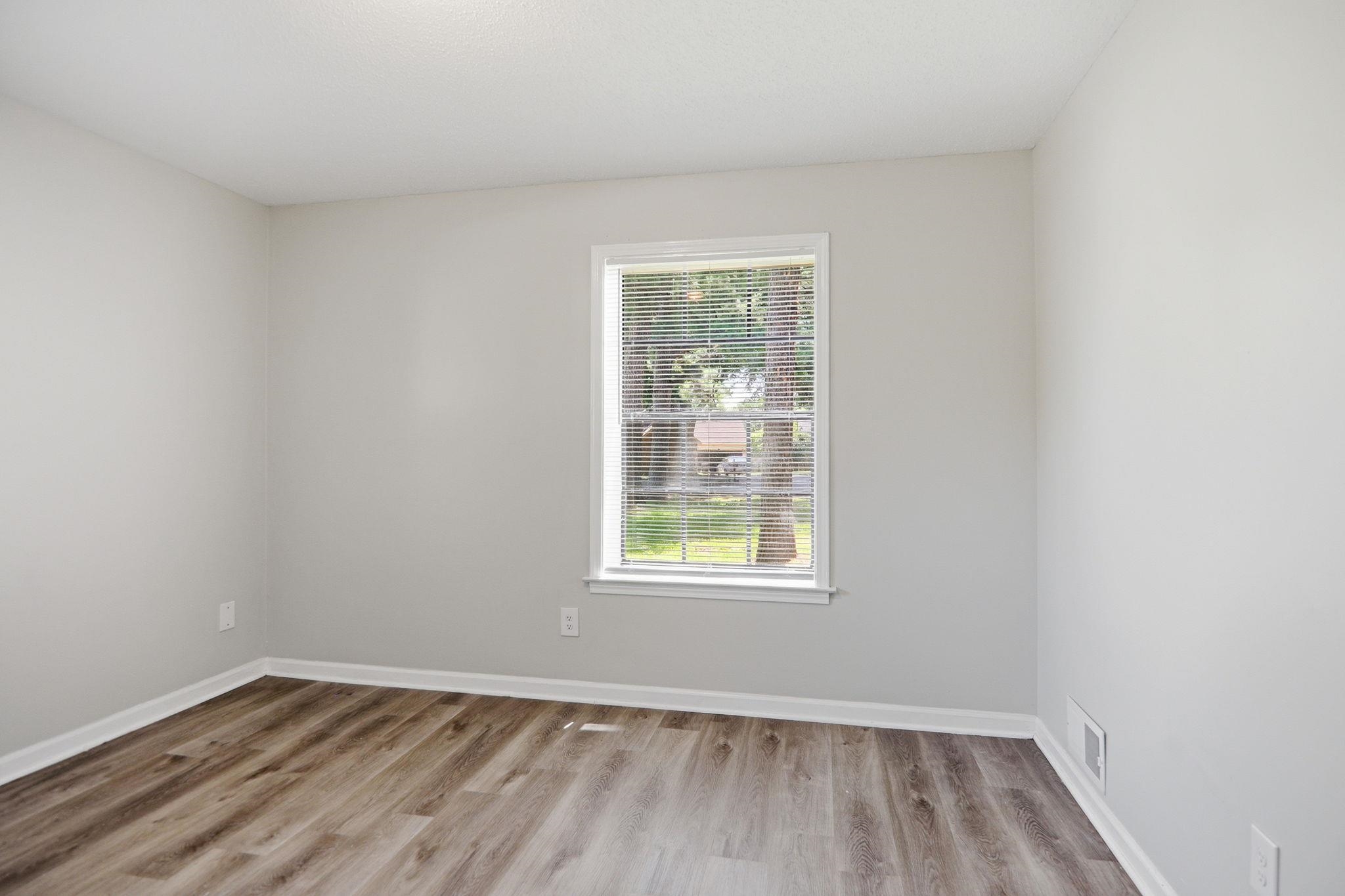 3113 Raleigh Ridge Cove Memphis, TN 38128 - Photo 19 of 38 Interior room featuring wood-finish flooring, light grey painted walls, and white trim