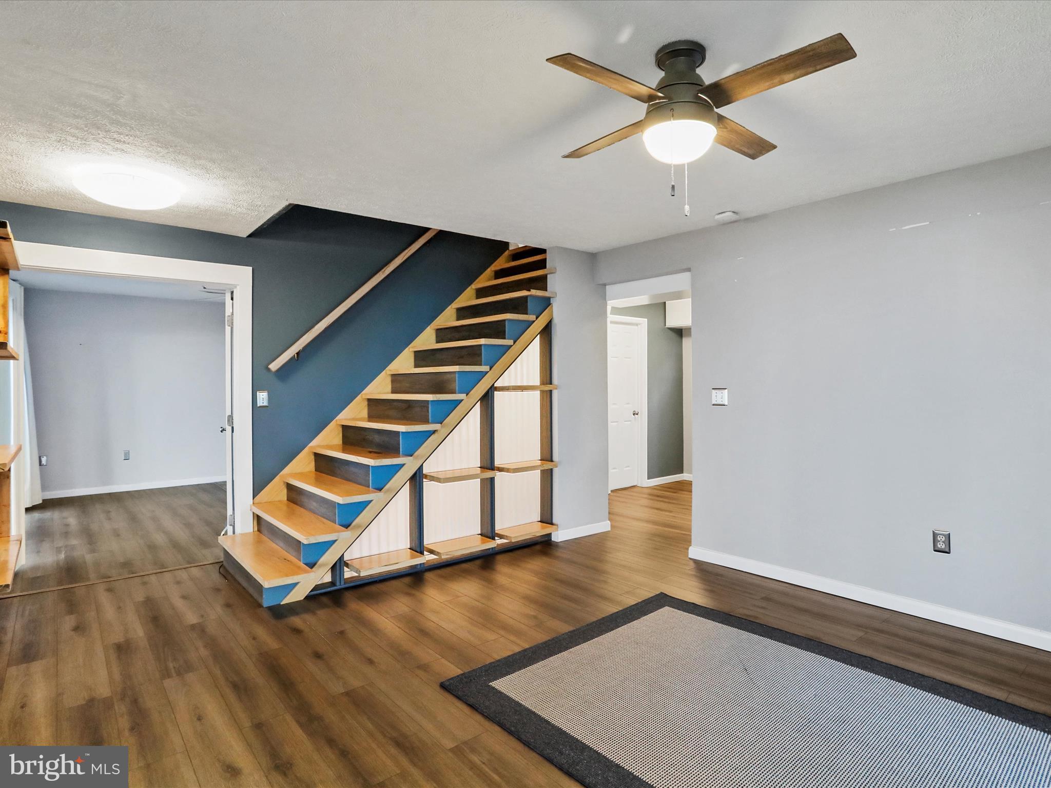 9475 Waxler Road Keyser, WV 26726 - Photo 11 of 61 wooden floor in a hall with a window and a ceiling fan