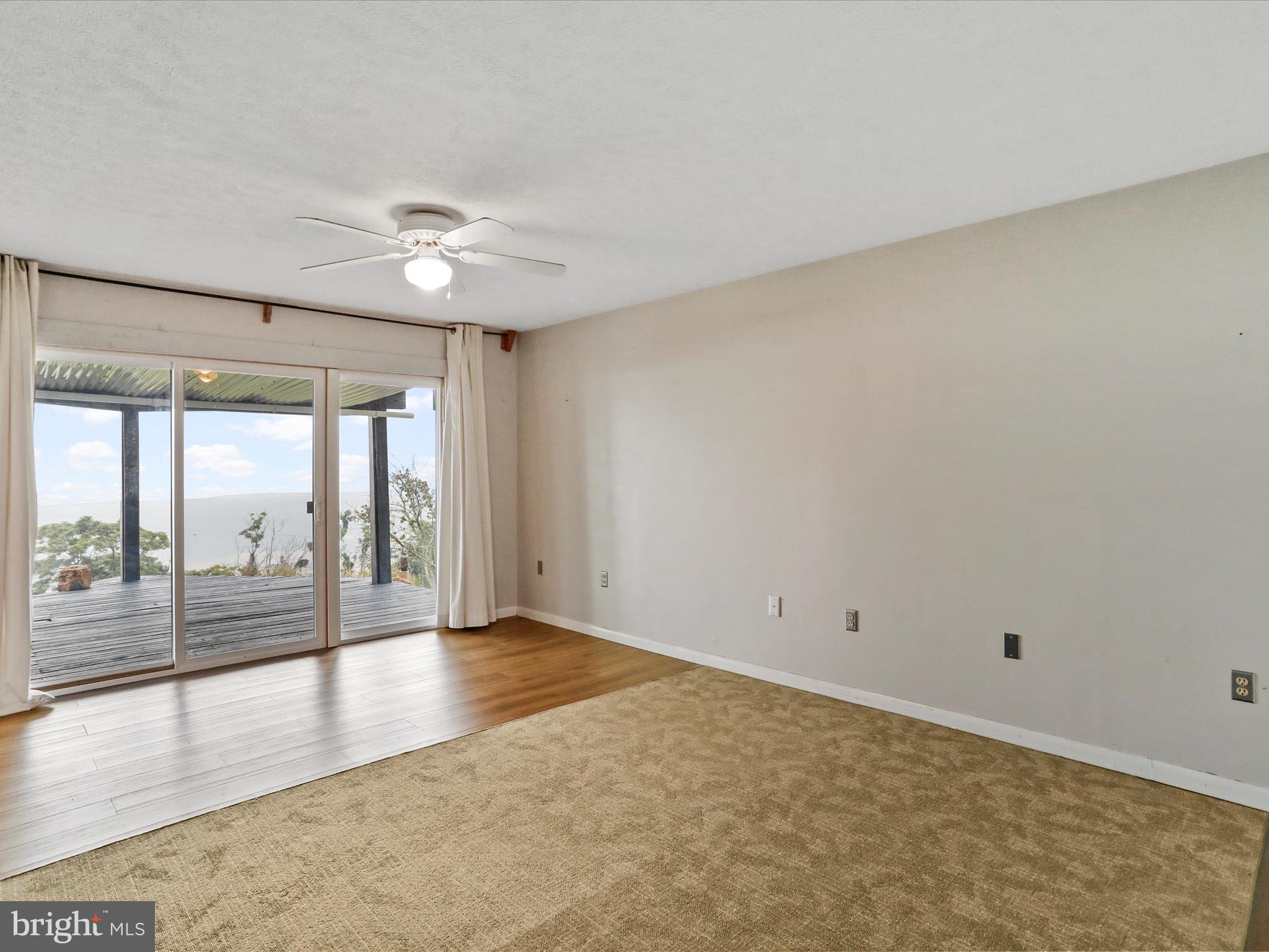9475 Waxler Road Keyser, WV 26726 - Photo 13 of 61 an empty room with wooden floor and windows