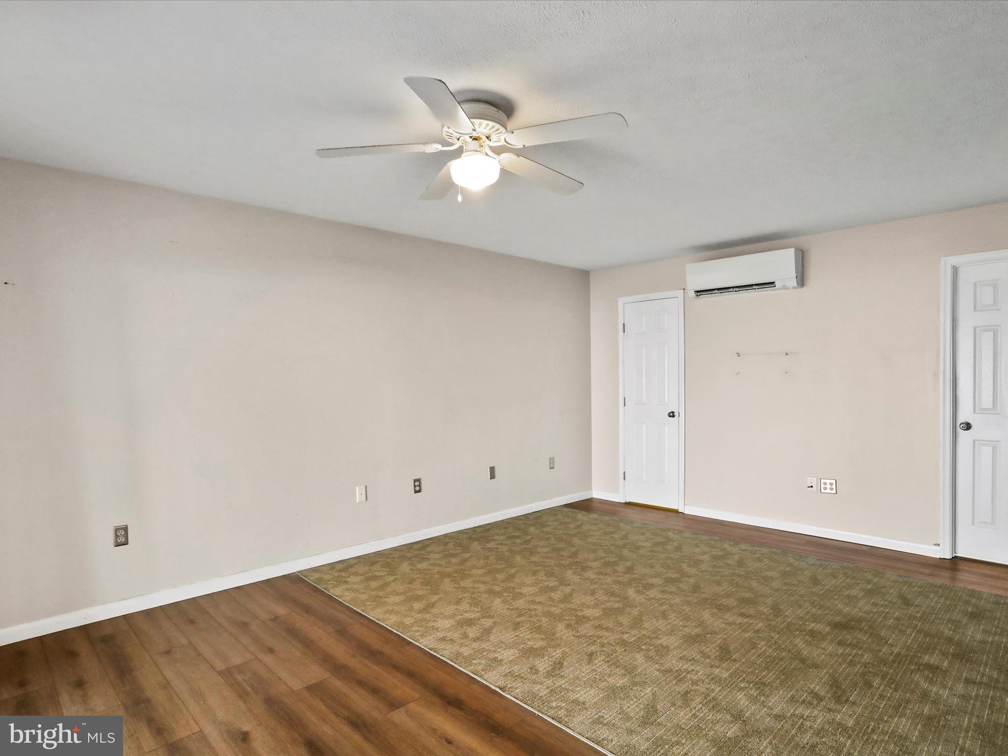 9475 Waxler Road Keyser, WV 26726 - Photo 15 of 61 an empty room with a ceiling fan and wooden floor