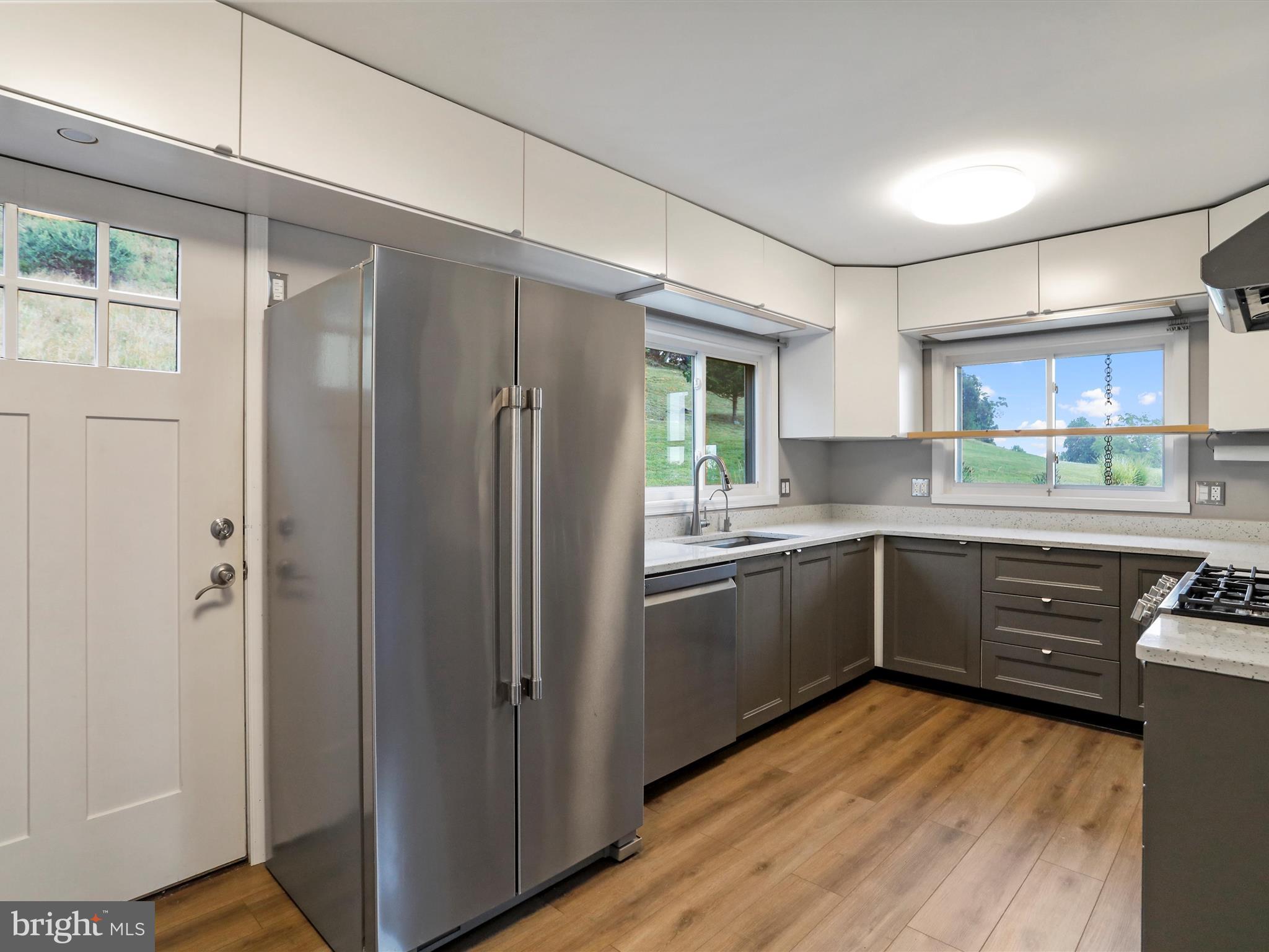 9475 Waxler Road Keyser, WV 26726 - Photo 17 of 61 a kitchen with a refrigerator a sink and cabinets