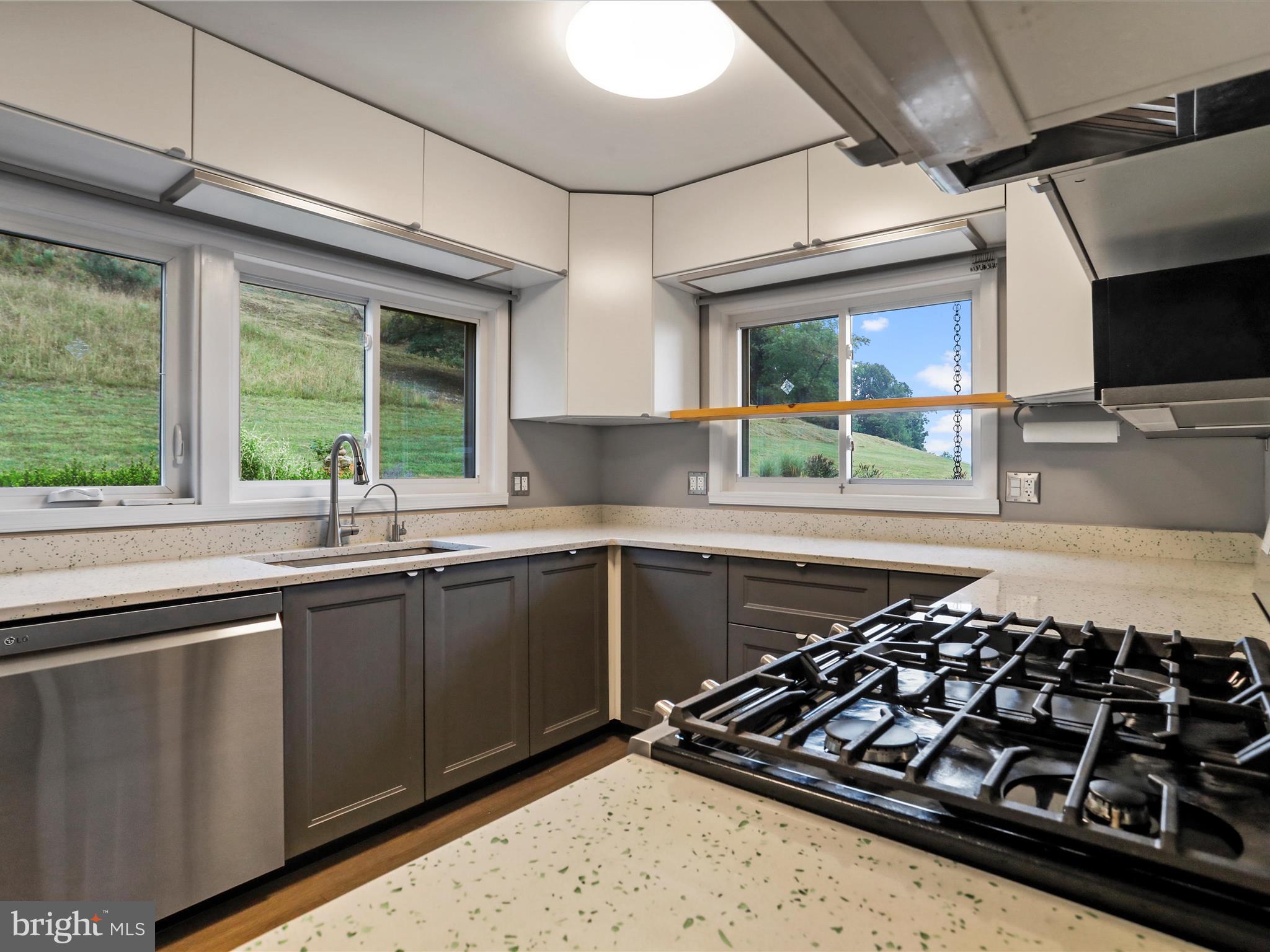 9475 Waxler Road Keyser, WV 26726 - Photo 19 of 61 a kitchen with wooden cabinets and a stove top oven