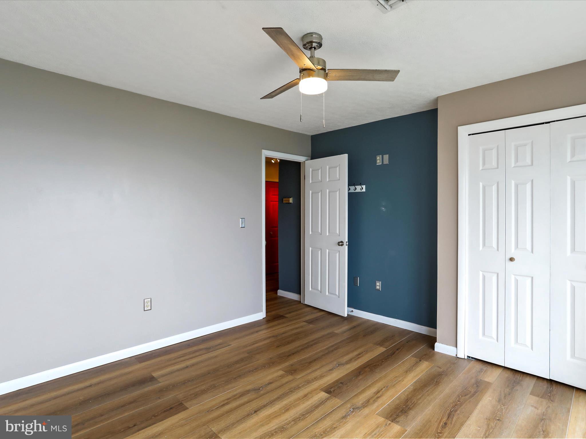 9475 Waxler Road Keyser, WV 26726 - Photo 23 of 61 an empty room with wooden floor and a ceiling fan