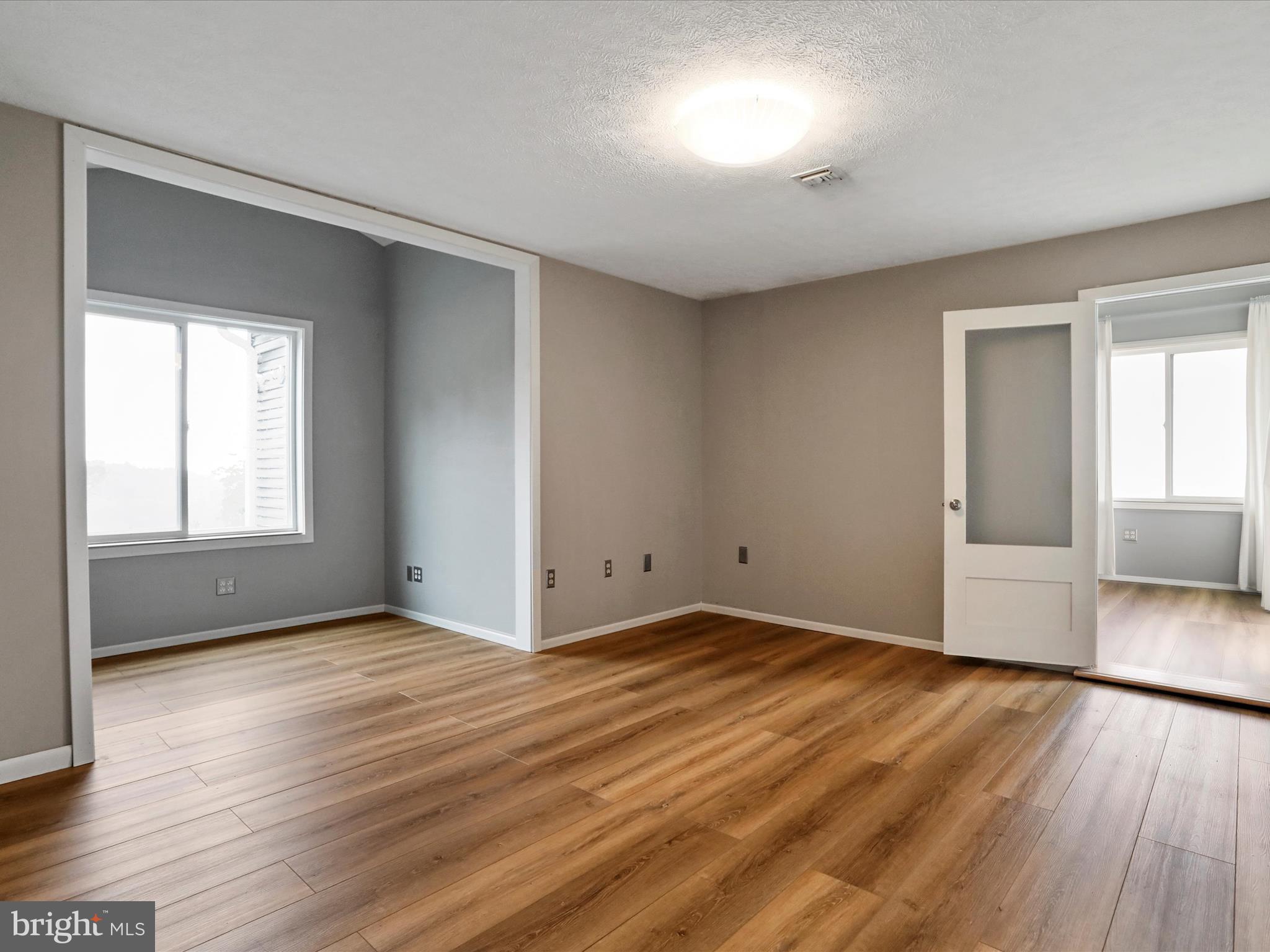 9475 Waxler Road Keyser, WV 26726 - Photo 28 of 61 an empty room with wooden floor and windows
