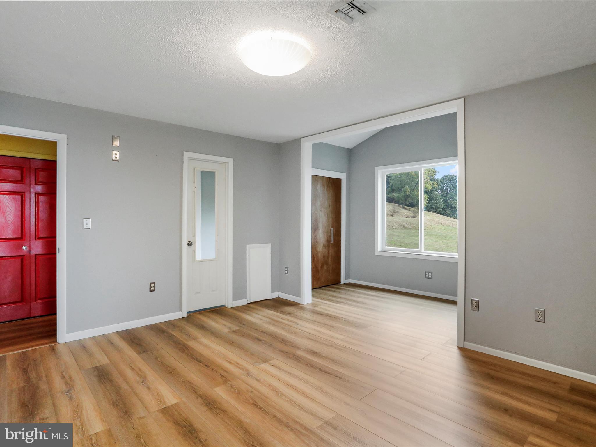 9475 Waxler Road Keyser, WV 26726 - Photo 29 of 61 a view of an empty room with wooden floor and a window